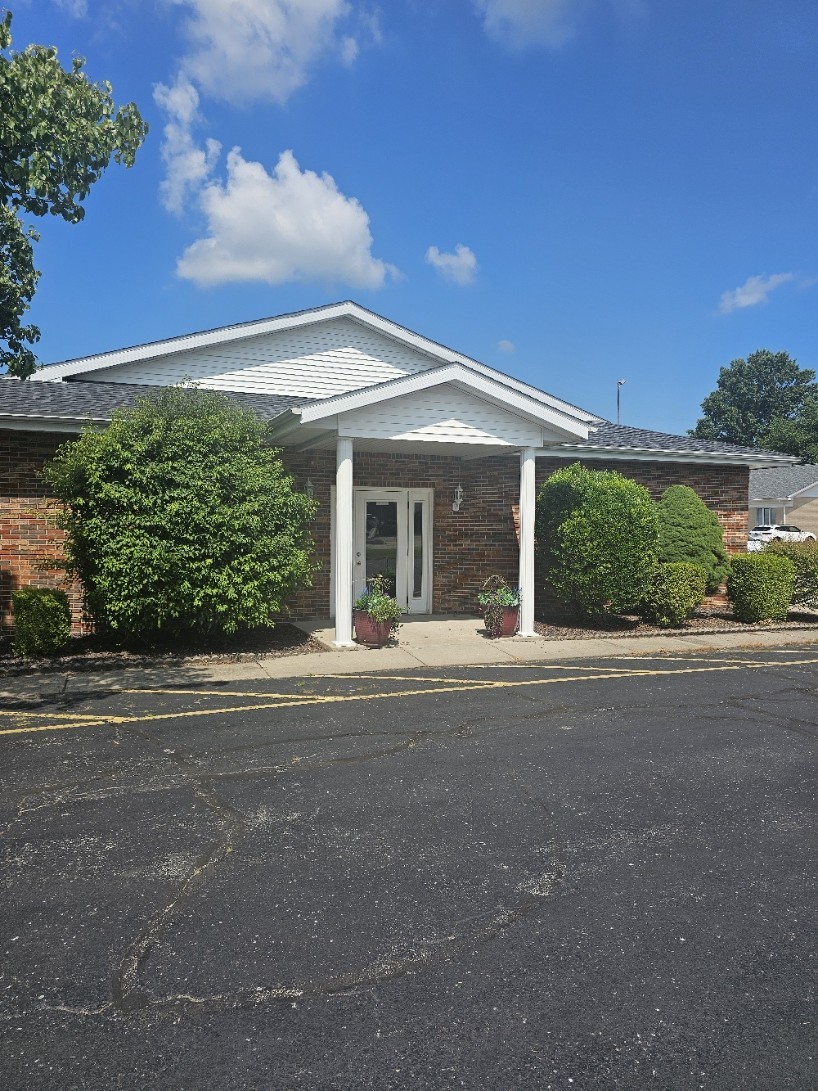 Front entrance of the 917 Clocktower Dr commercial building in Springfield, IL, with covered portico and landscaping